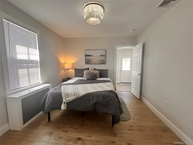 a kitchen with a sink and wooden floor