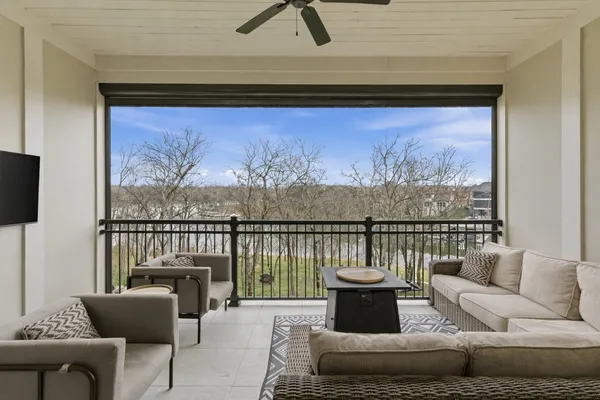 a living room with furniture and a floor to ceiling window