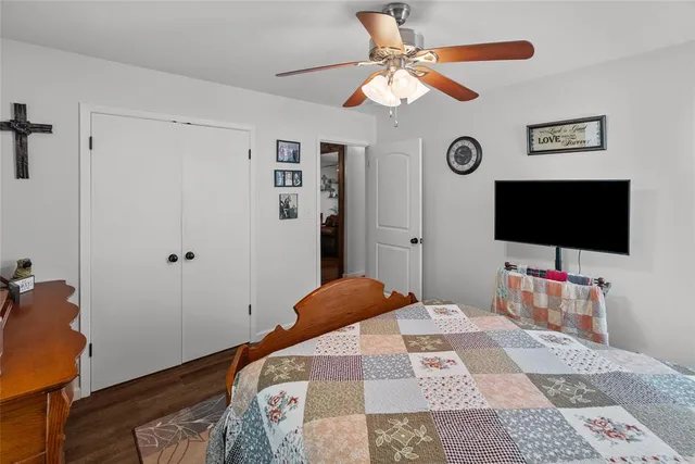 a bedroom with a bed a dresser and book shelf