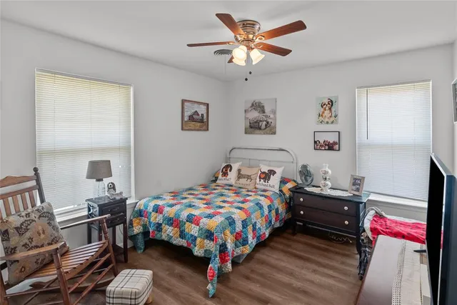 a view of a car in front of a house with a yard
