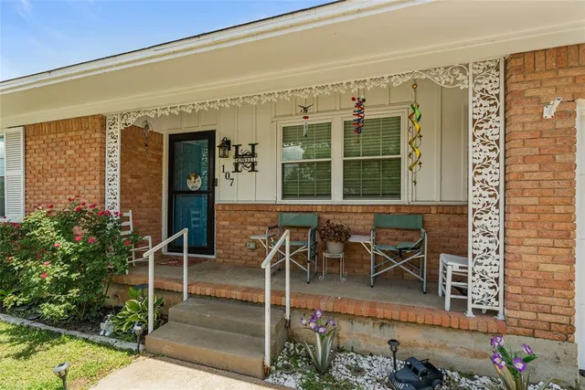a living room with furniture kitchen view and a flat screen tv