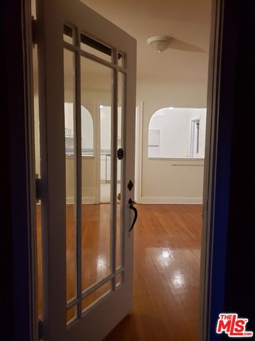 a view of room with window and wooden floor
