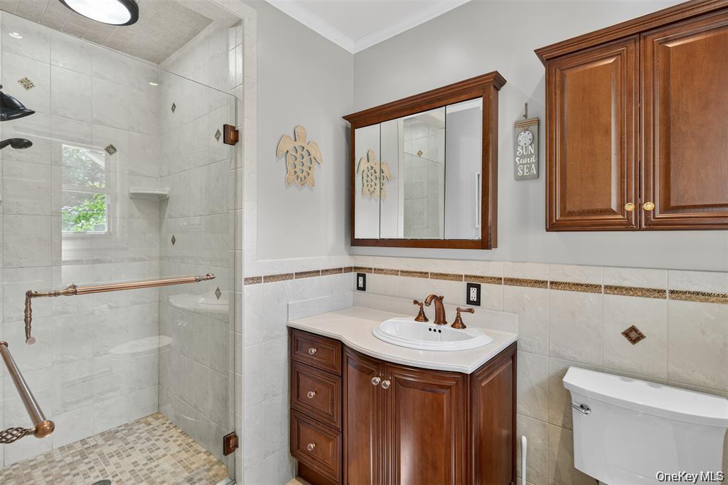 73 Old Balmville Road Newburgh, NY 12550 - Photo 18 of 25 a bathroom with a sink a toilet and shower