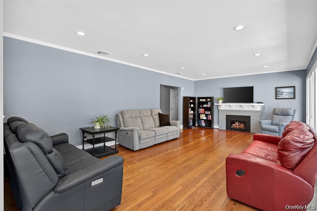 73 Old Balmville Road Newburgh, NY 12550 - Photo 4 of 25 a living room with furniture a fireplace and a flat screen tv