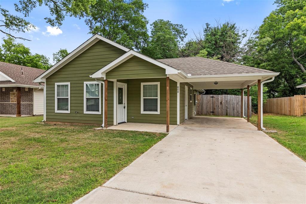 804 East 5th Street Bonham, TX 75418 - Photo 1 of 15 a view of a house with a yard plants and large tree