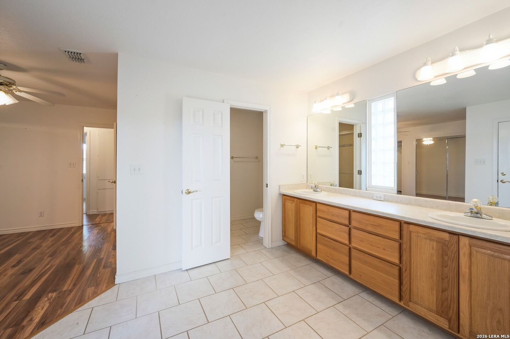 162 Oakside Universal City, TX 78148 - Photo 18 of 31 a spacious bathroom with a double vanity sink a mirror and a