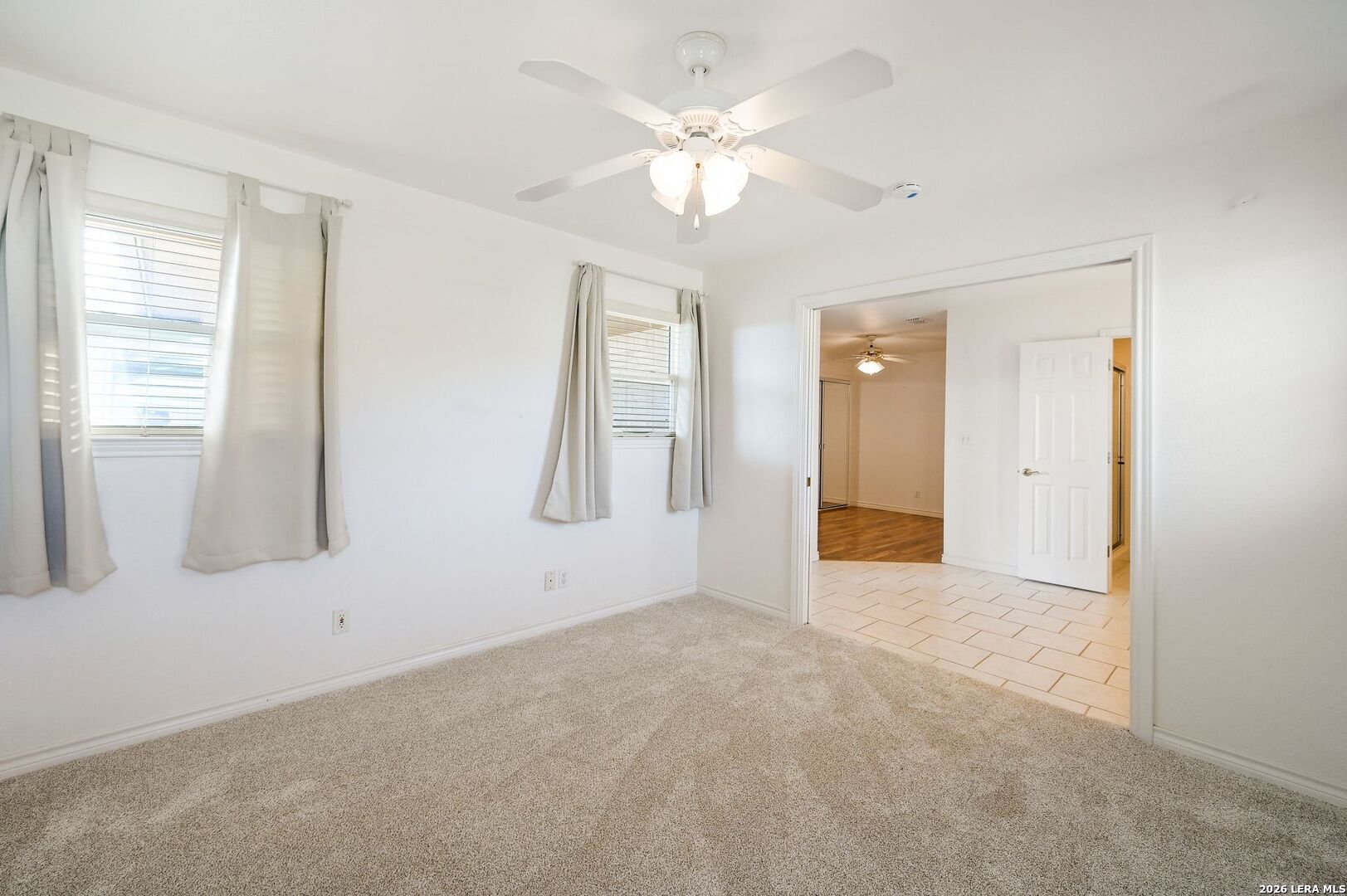 162 Oakside Universal City, TX 78148 - Photo 20 of 31 an empty room with windows and fan