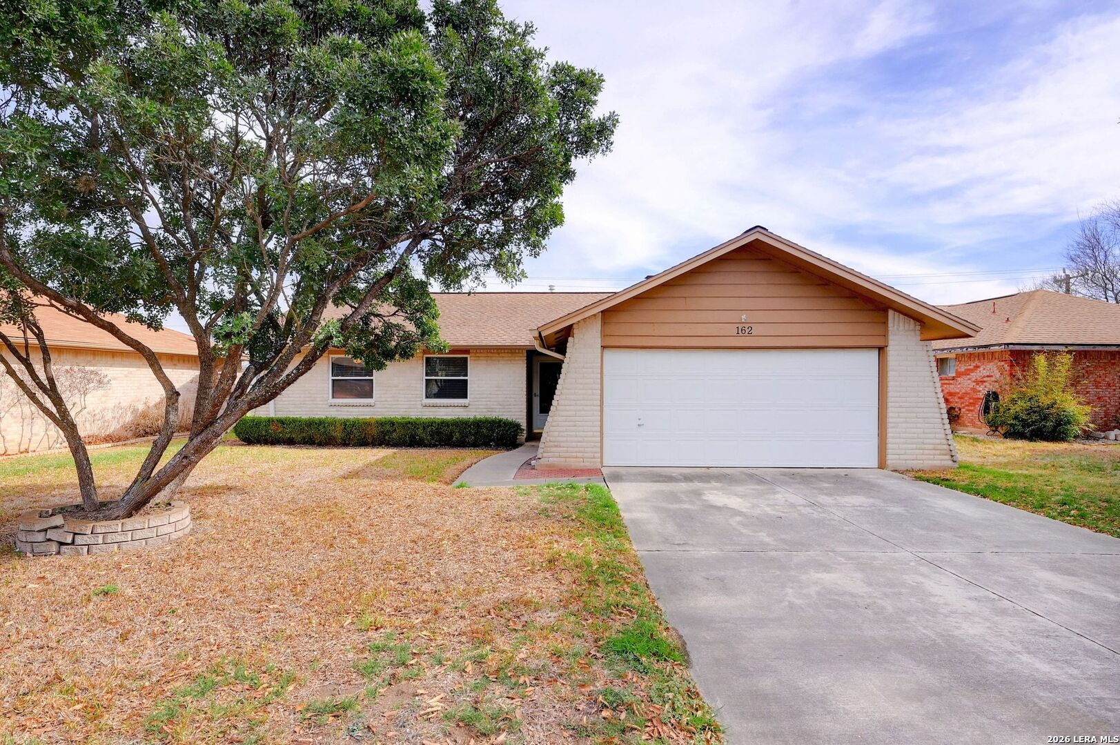 162 Oakside Universal City, TX 78148 - Photo 2 of 31 a front view of a house with a yard and garage