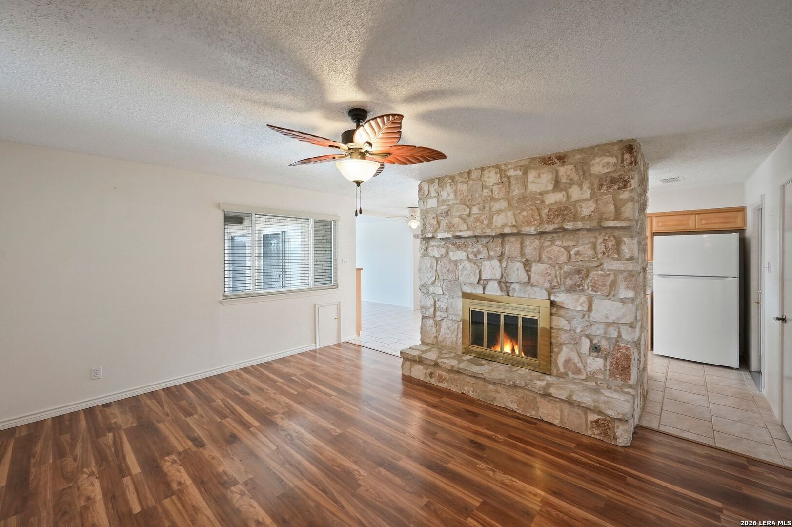 162 Oakside Universal City, TX 78148 - Photo 4 of 31 a living room with a fireplace and wooden floor