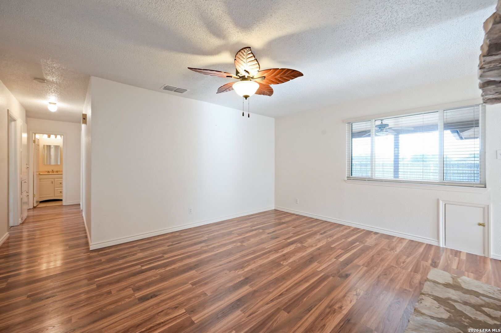 162 Oakside Universal City, TX 78148 - Photo 7 of 31 wooden floor in an empty room with a window