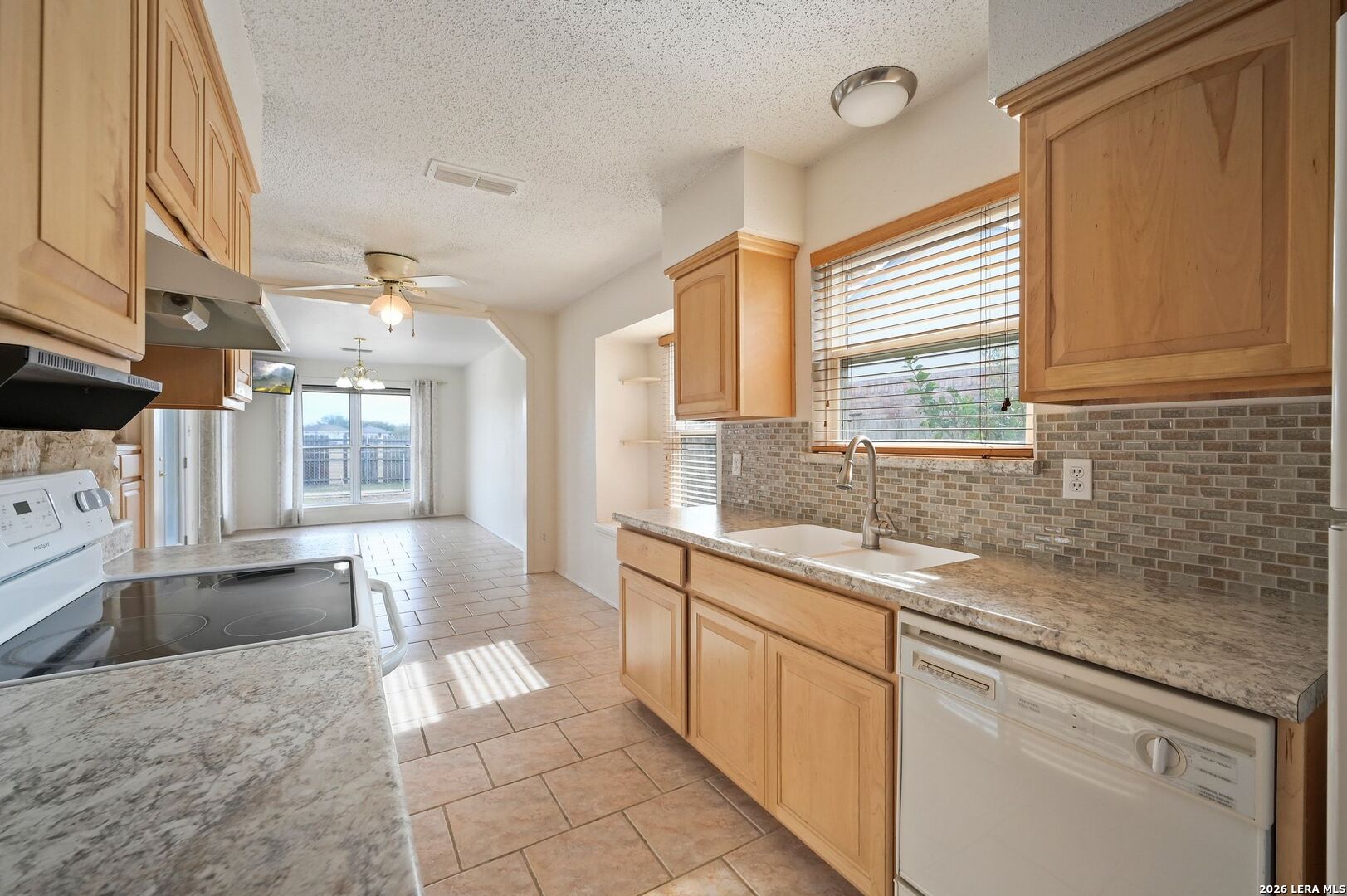 162 Oakside Universal City, TX 78148 - Photo 8 of 31 a kitchen with a sink stove and cabinets