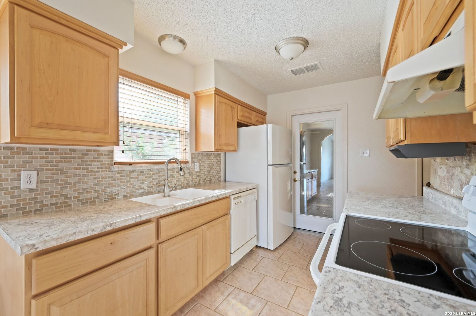 162 Oakside Universal City, TX 78148 - Photo 9 of 31 a kitchen with a sink stove and cabinets