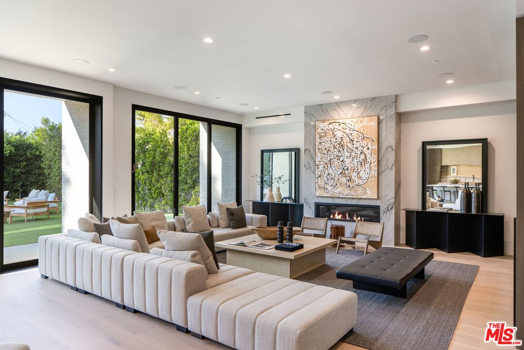 17055 Rancho Street Encino, CA 91316 - Photo 40 of 73 a living room with furniture and a large window