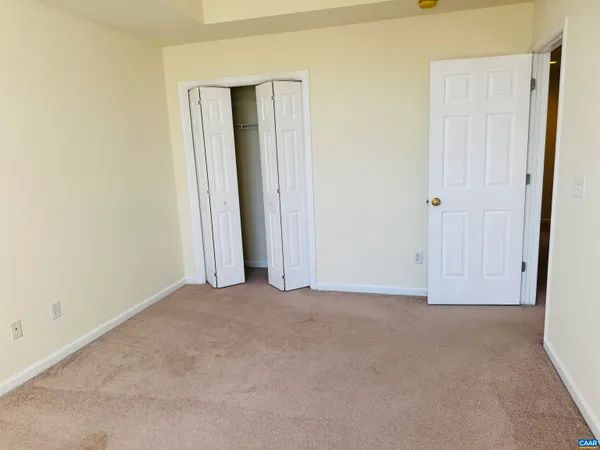 an empty room with closet area
