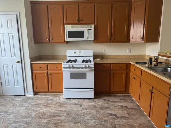 a kitchen with a stove and a microwave