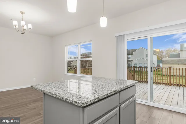 a kitchen with granite countertop sink and wooden floor