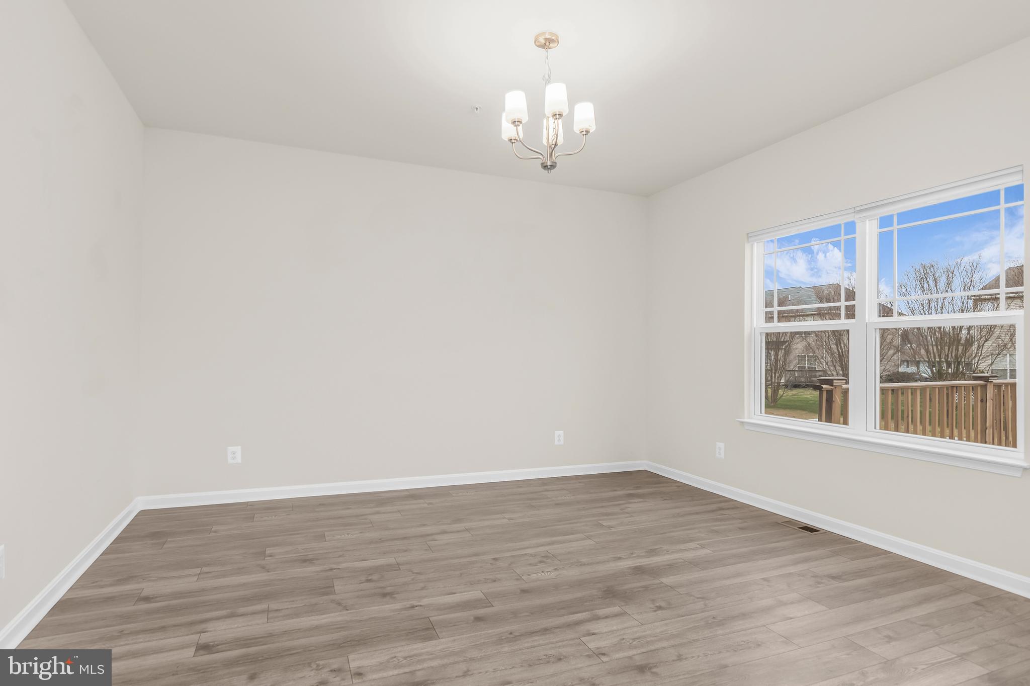 319 Appleby School Road Cambridge, MD 21613 - Photo 14 of 29 a view of a room with wooden floor and large windows