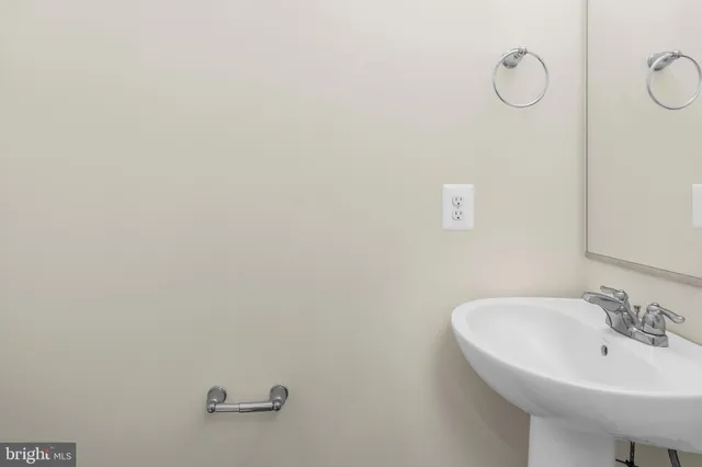 a bathroom with a sink and mirror