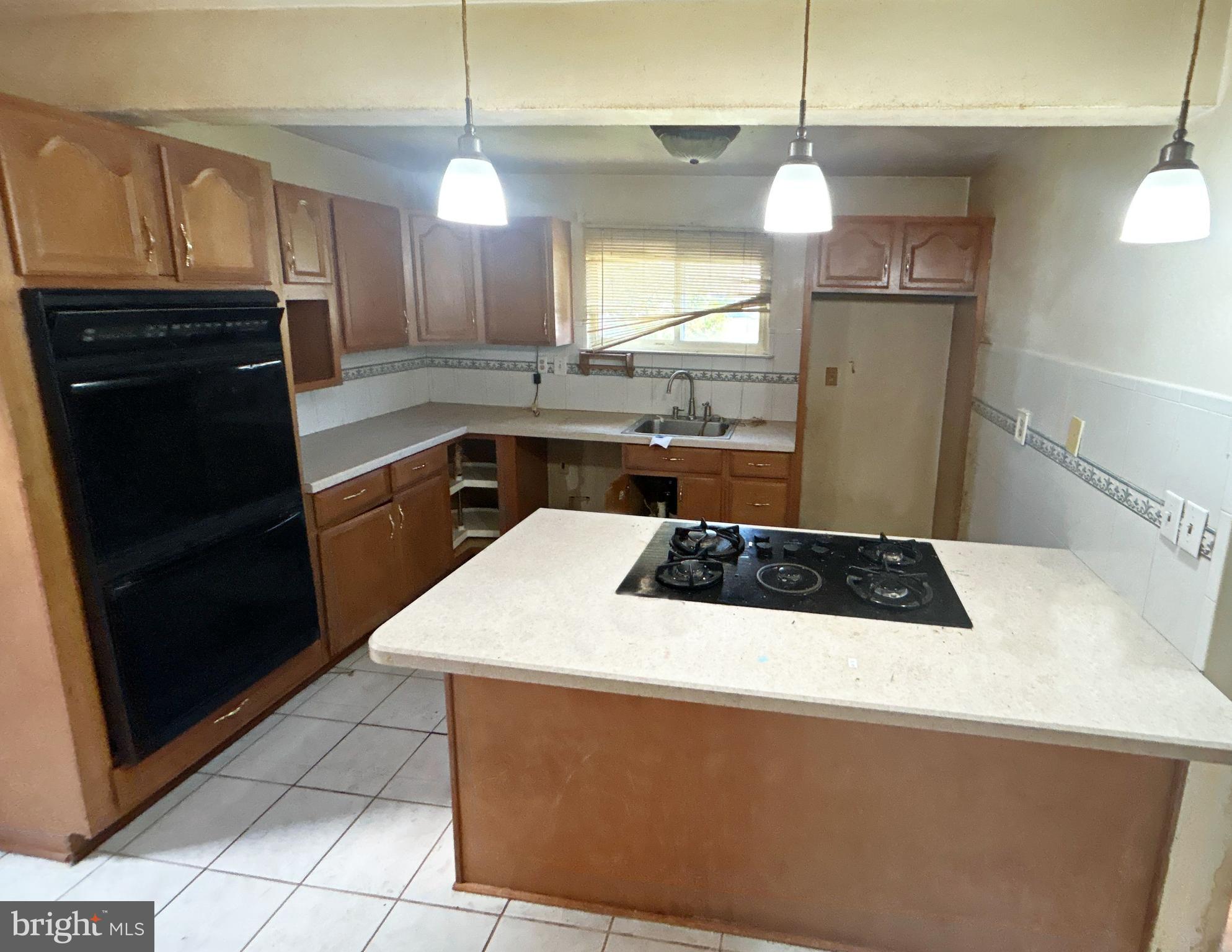 311 Ferndale Road Glen Burnie, MD 21061 - Photo 9 of 21 a kitchen with a sink a stove a refrigerator and cabinets