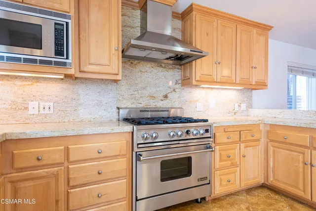 a kitchen with granite countertop white cabinets and appliances