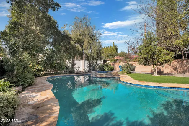 a view of a swimming pool with a yard