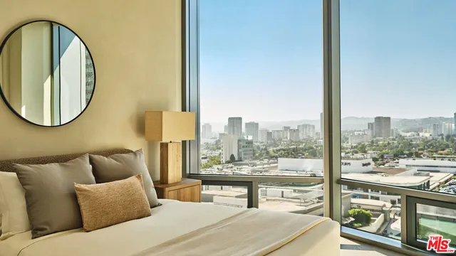 a living room with furniture and a floor to ceiling window