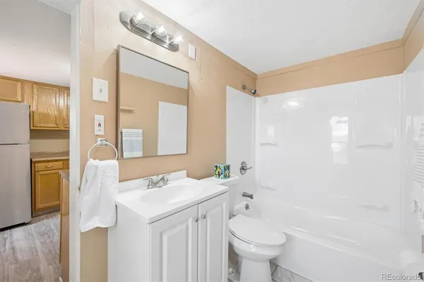 a bathroom with a sink a toilet and a large mirror