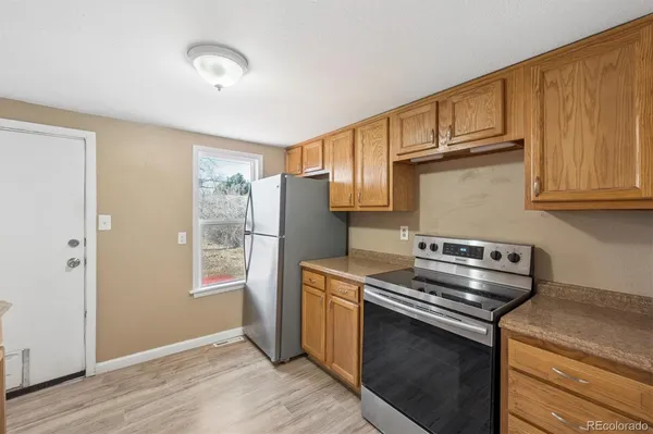 a kitchen with stainless steel appliances granite countertop a stove and a refrigerator