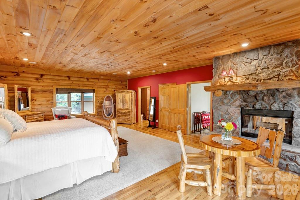 35 Falcon Crest Loop Maggie Valley, NC 28751 - Photo 16 of 46 a bedroom with furniture and large windows