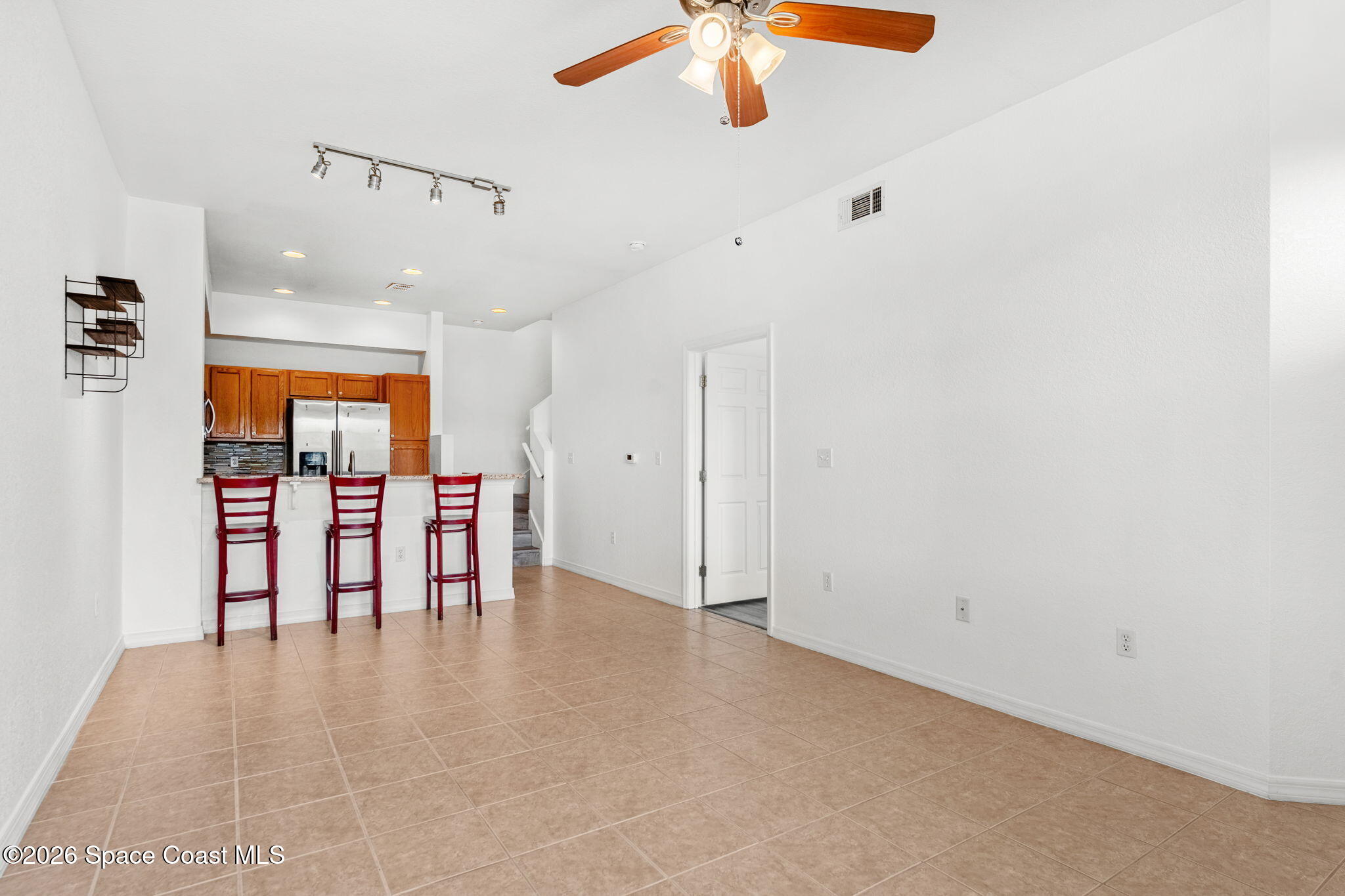 110 Turpial Way, Unit 106 Melbourne, FL 32901 - Photo 13 of 50 an empty room with chandelier fan and outdoor view