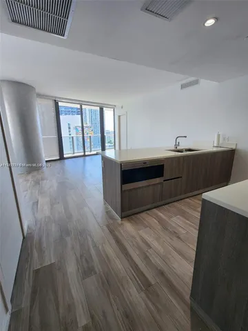 a view of a kitchen with a sink and cabinets