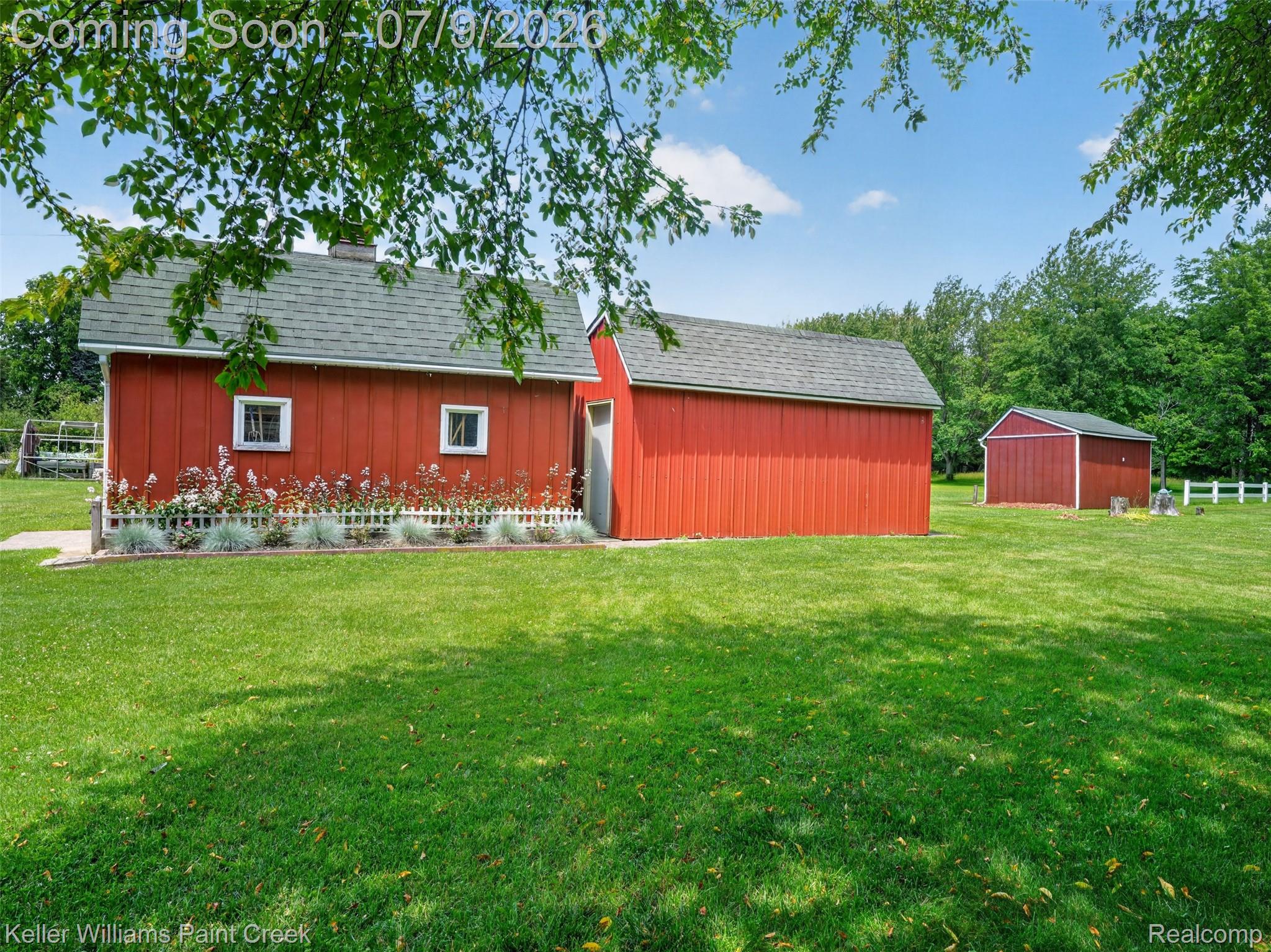 204 Russell Road Kawkawlin, MI 48631 - Photo 53 of 82 Expansive lawn surrounding multiple red outbuildings with gray shingle roofs