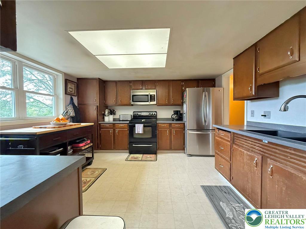 2507 Rachael Lane Orefield, PA 18069 - Photo 17 of 53 a kitchen with stainless steel appliances a stove a sink a microwave a refrigerator and cabinets