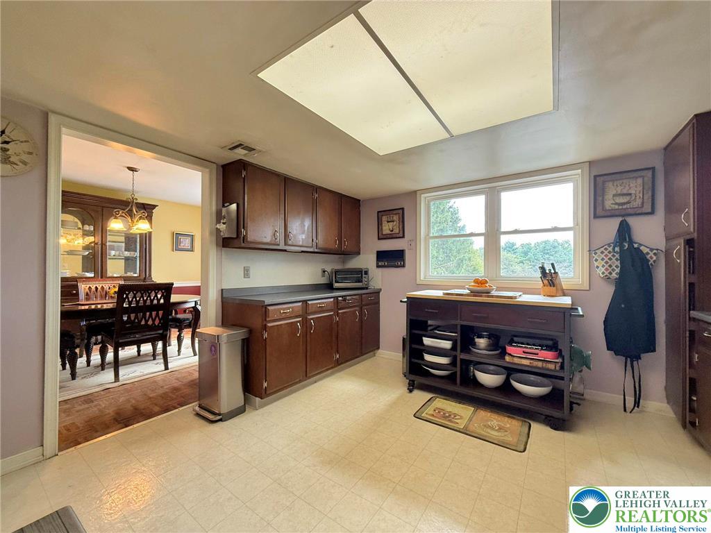 2507 Rachael Lane Orefield, PA 18069 - Photo 18 of 53 a kitchen with stainless steel appliances granite countertop a refrigerator a stove a sink a dining table and chairs with the view