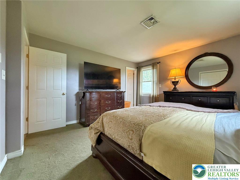 2507 Rachael Lane Orefield, PA 18069 - Photo 21 of 42 a bedroom with a bed and a flat screen tv