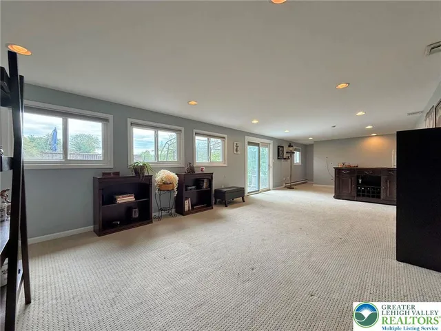 a living room with furniture a couch and a window