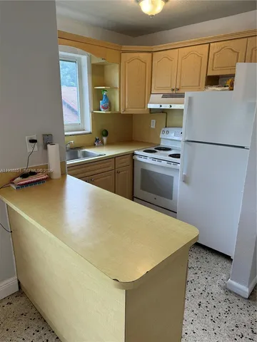a kitchen with a stove and a refrigerator