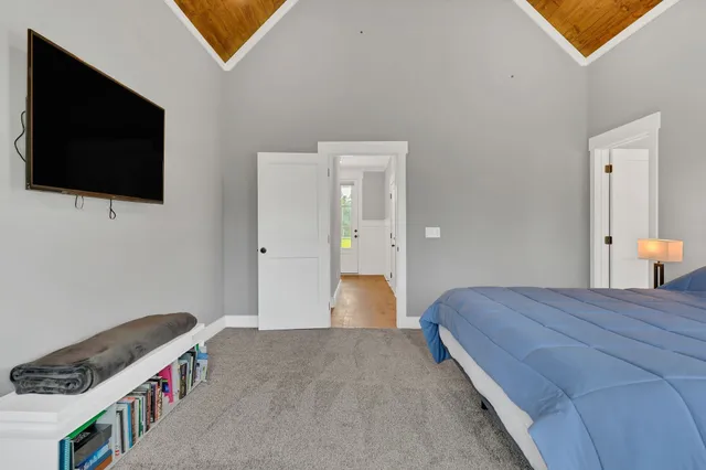 a bedroom with a bed and a flat screen tv