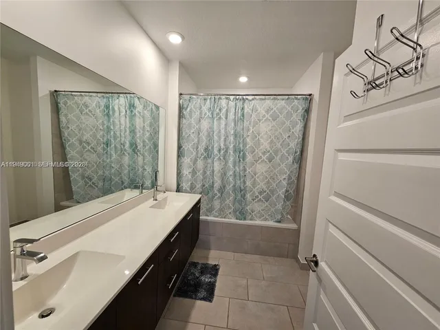 a bathroom with a sink and a shower
