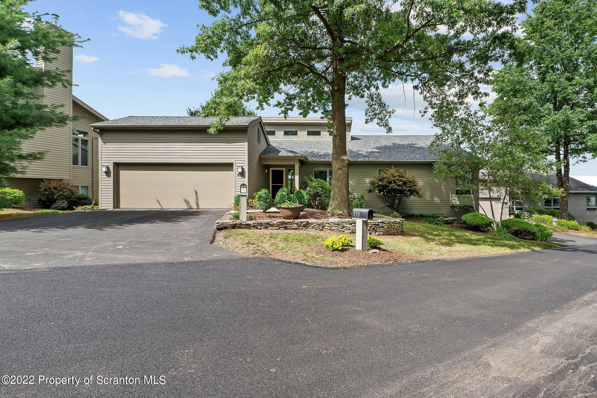 773 Greens Dallas, PA 18612 - Photo 39 of 44 a front view of a house with a garden and trees