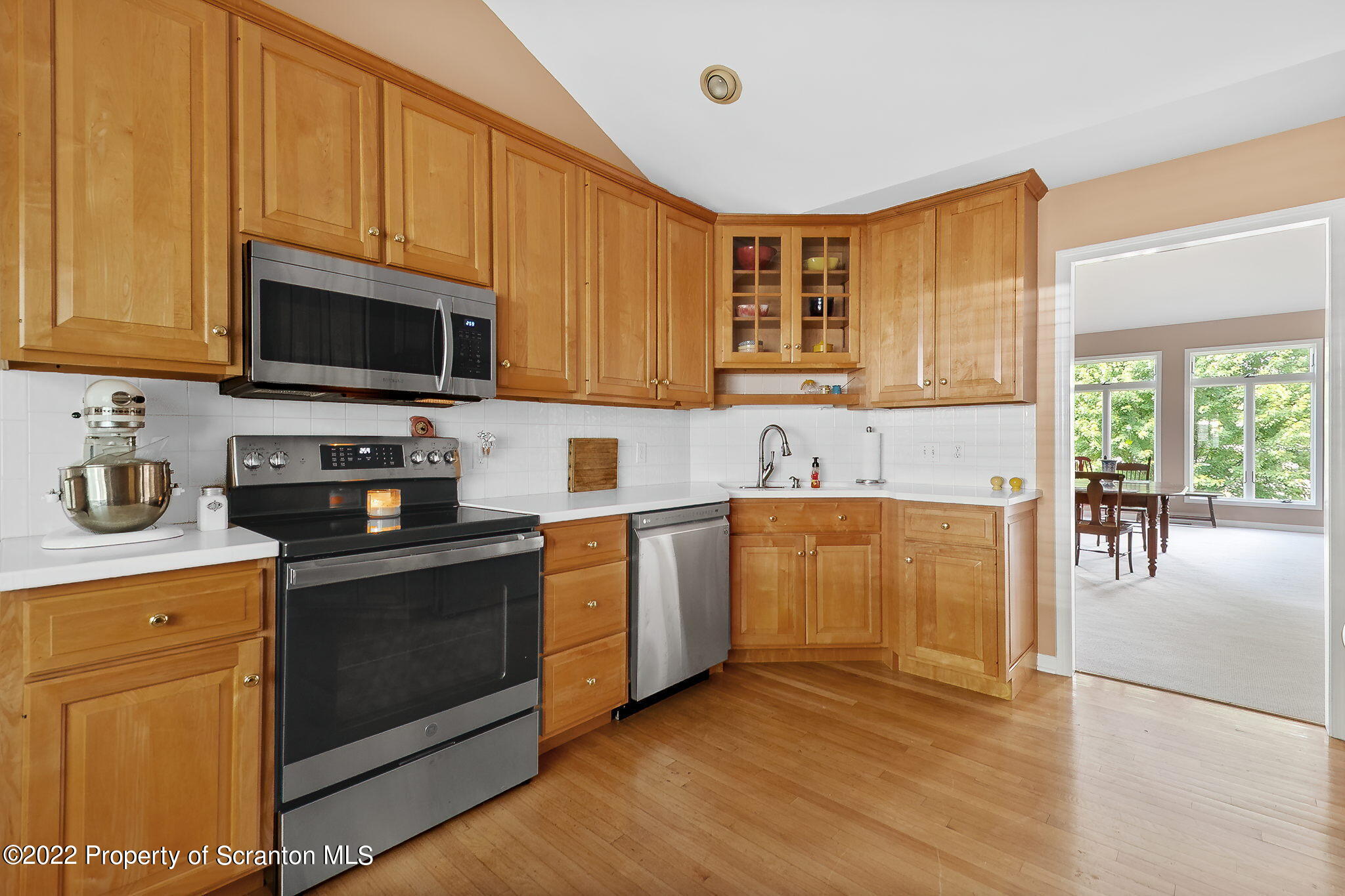 773 Greens Dallas, PA 18612 - Photo 7 of 44 a kitchen with stainless steel appliances granite countertop a stove a sink dishwasher and a microwave oven with wooden cabinets
