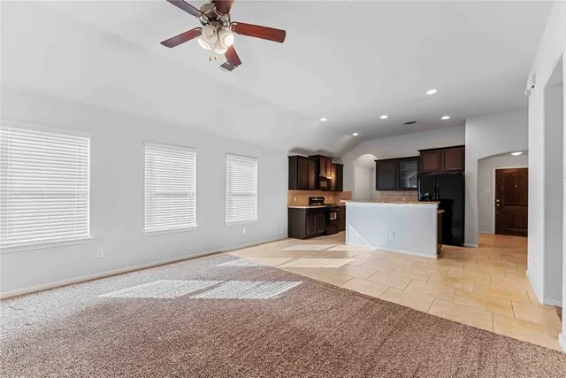 a kitchen with stainless steel appliances granite countertop a refrigerator and a stove top oven