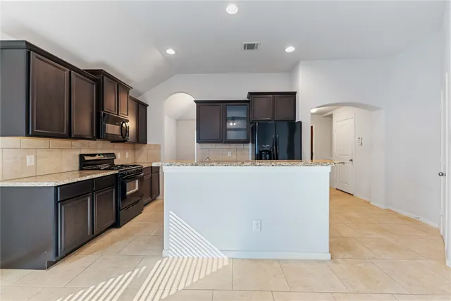 a kitchen with a refrigerator stove and a sink