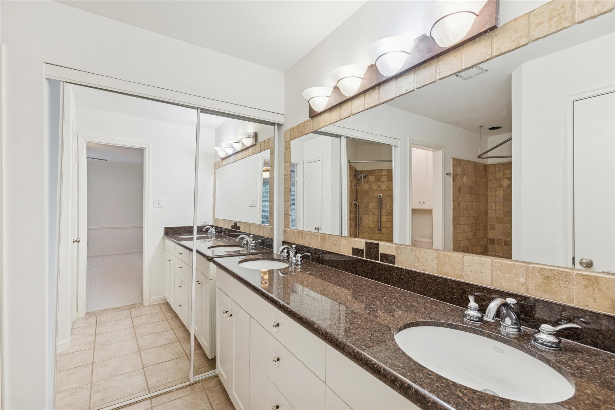 12 Lakeridge Drive Spring, TX 77381 - Photo 10 of 24 Primary bathroom with a double vanity, stone countertops, updated lighting, and a spacious walk-in shower.