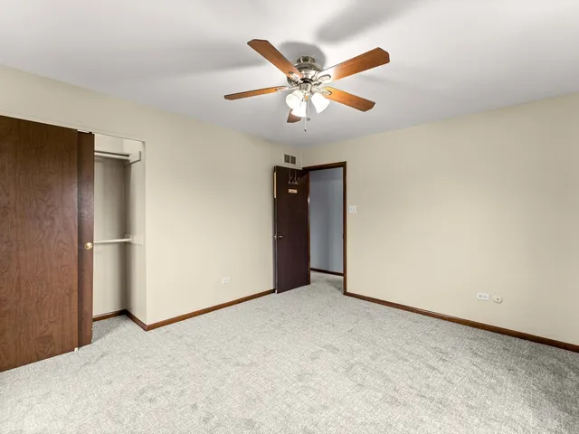 a view of an empty room with a ceiling fan