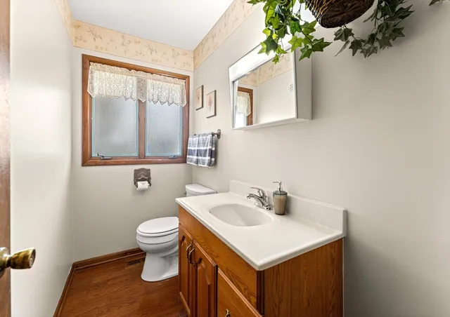 a bathroom with a sink toilet and mirror