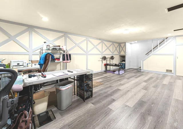 a kitchen with stainless steel appliances granite countertop a sink a stove and a wooden floors