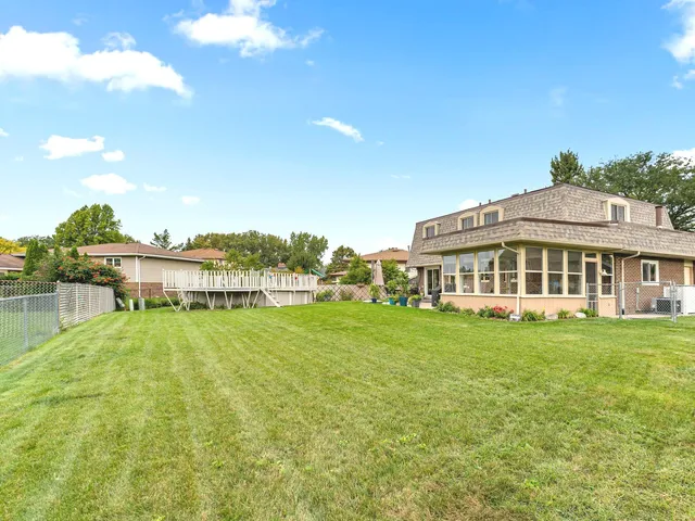 a view of a house with big yard and a large pool