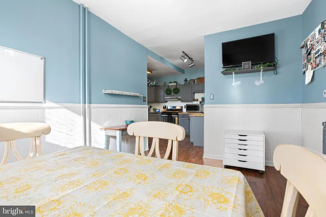 a bedroom with a bed a flat screen tv and a couch