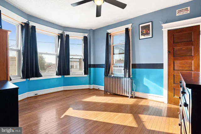 a living room with furniture and a dresser